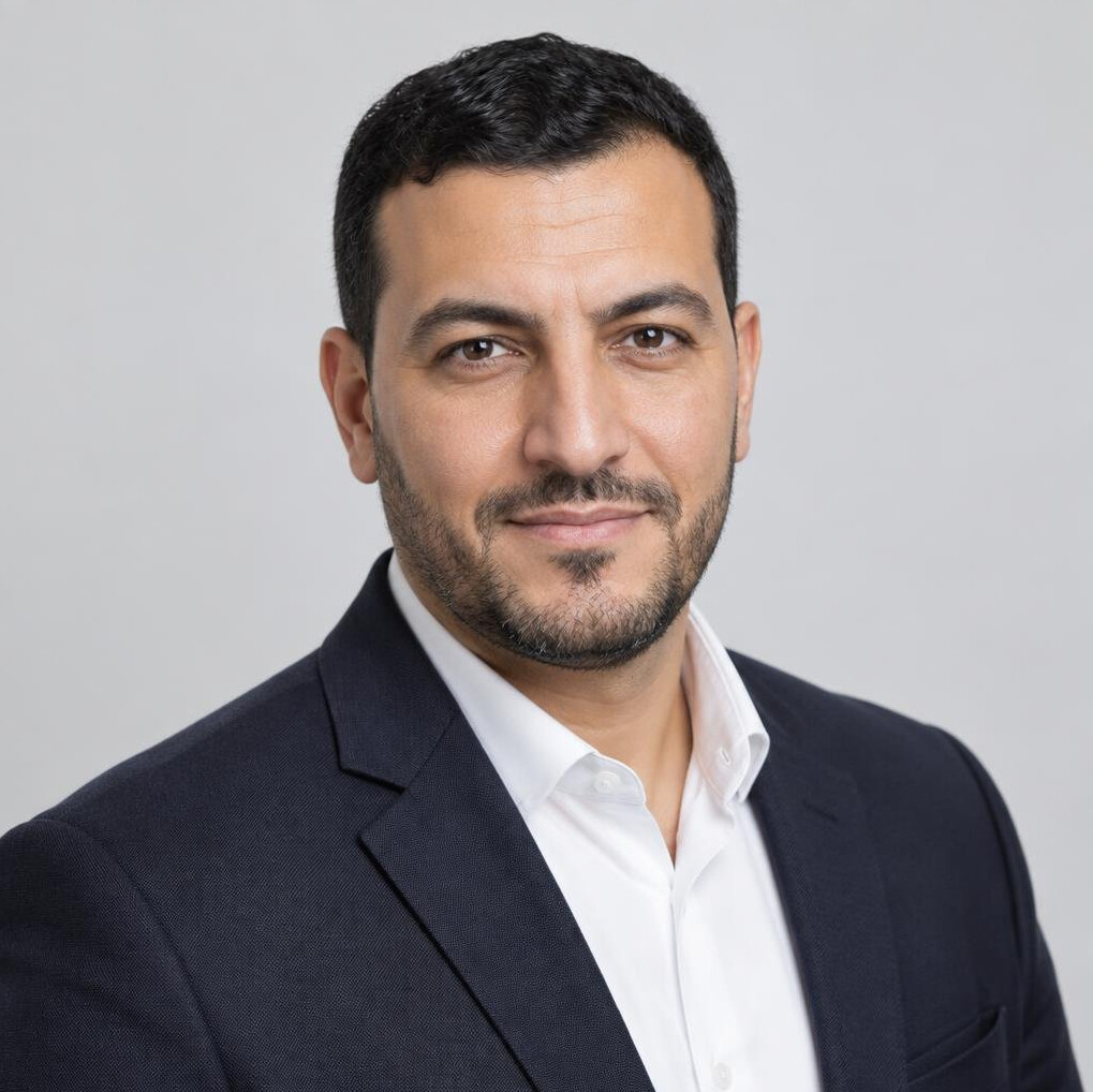 Studio portrait of a North African Belgian man consultant in a suit